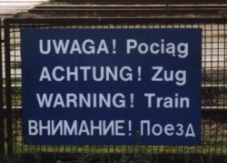 ['WARNING! Train' in Polish, German, English and Russian]
